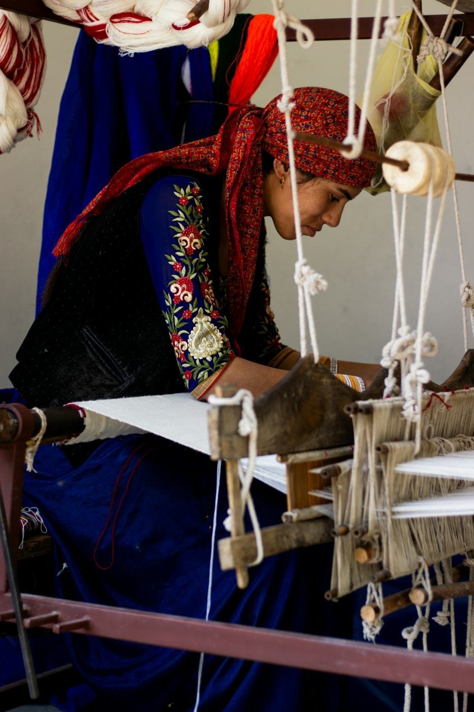 An artisan weaving on a traditional handloom