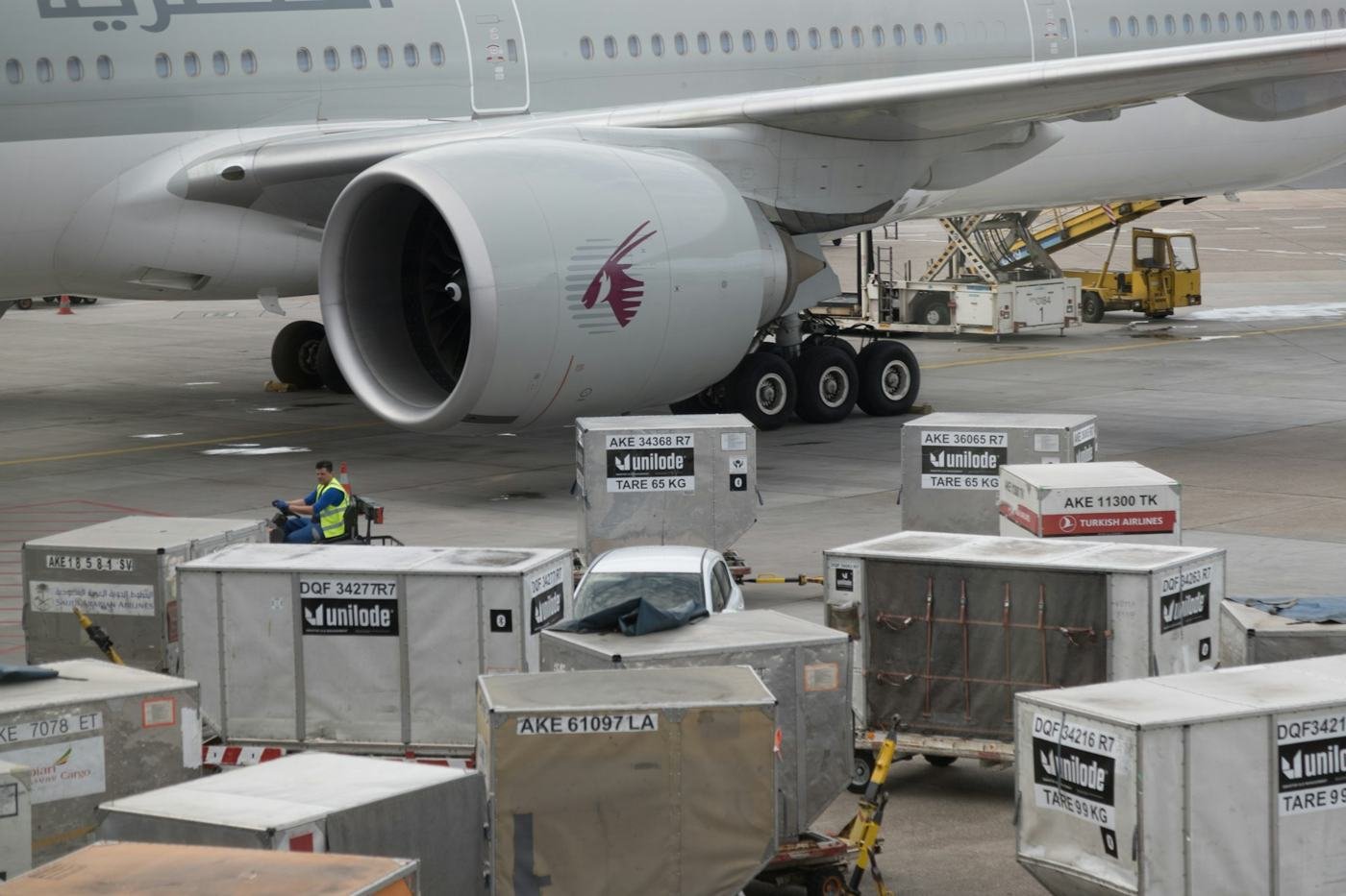 An aircraft being loaded with cargo at an airport