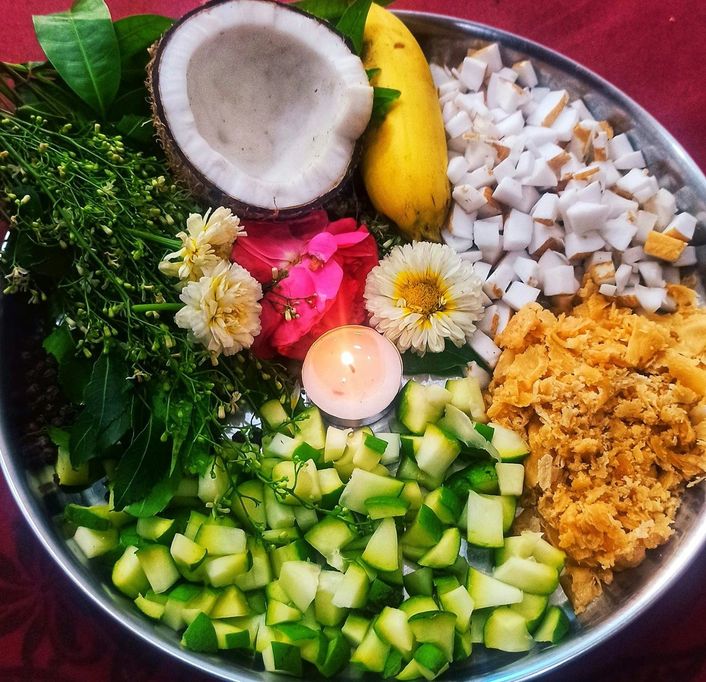 A pooja thali with flowers and ritual items