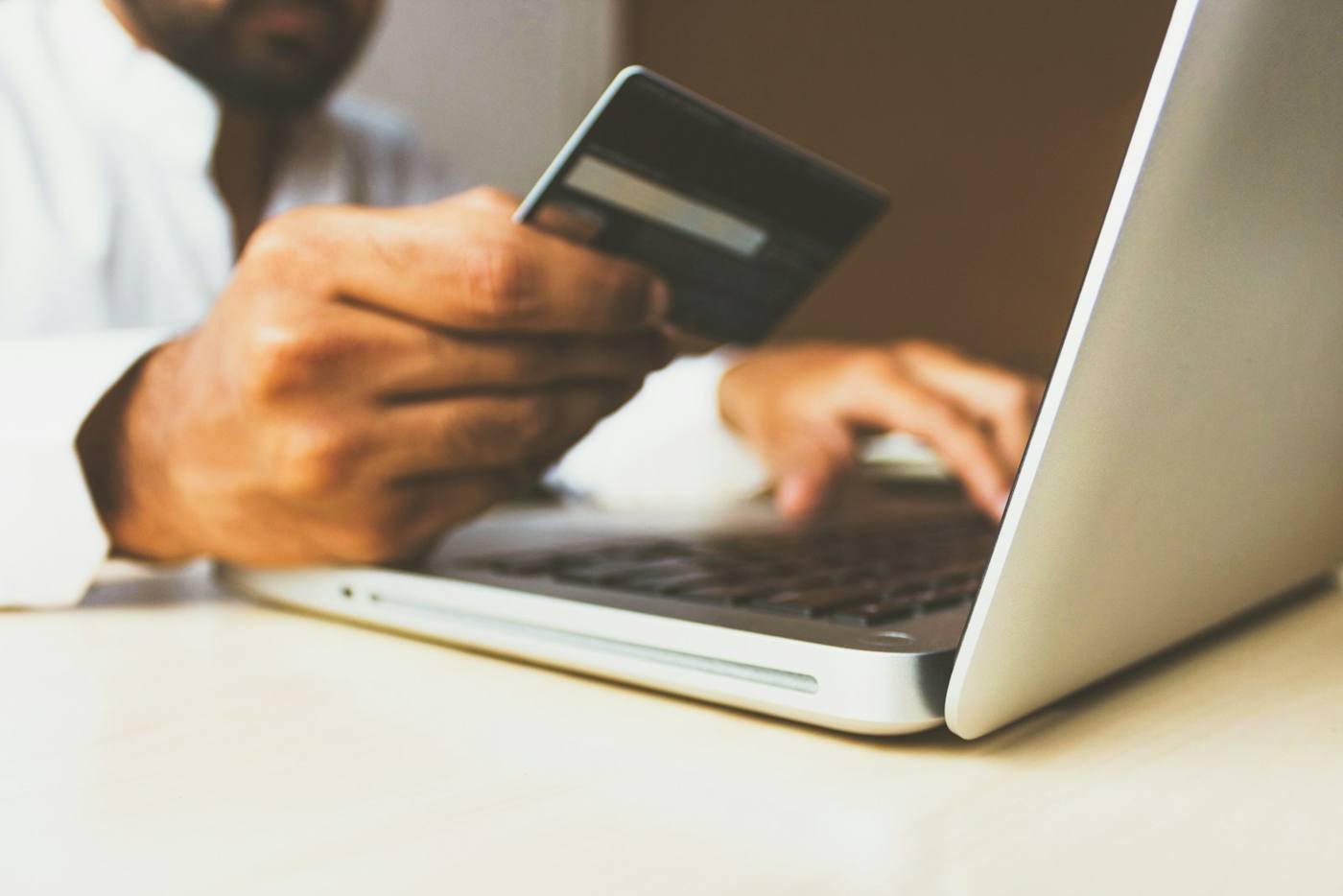 Paying online with a card on a laptop