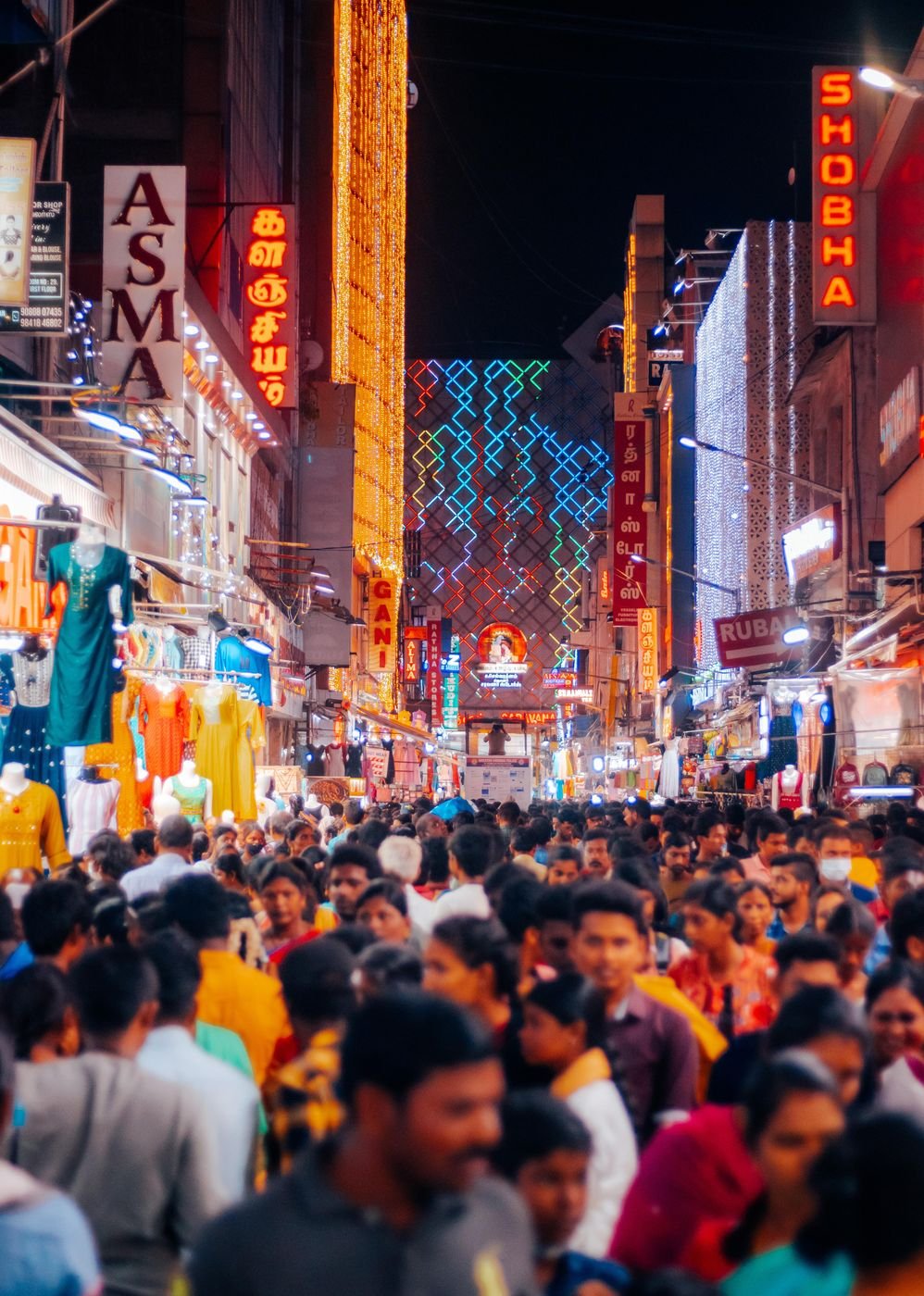Crowds shopping on a lit-up street in T. Nagar, Chennai, at night